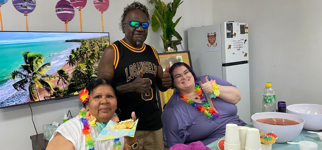 Compassionate support worker assisting a client indoors